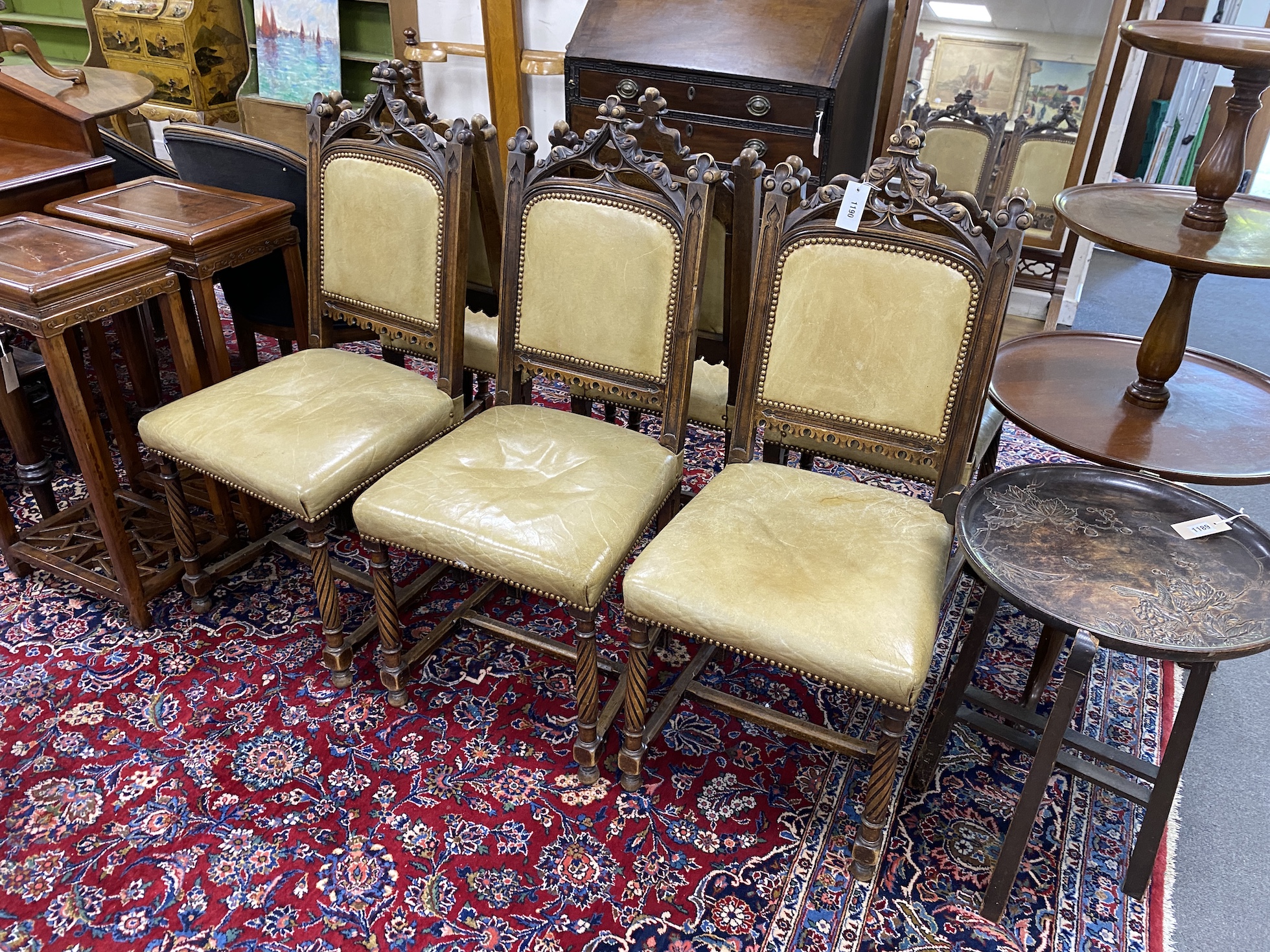 A set of six late Victorian carved walnut Gothic style dining chairs, width 40cm, height 107cm